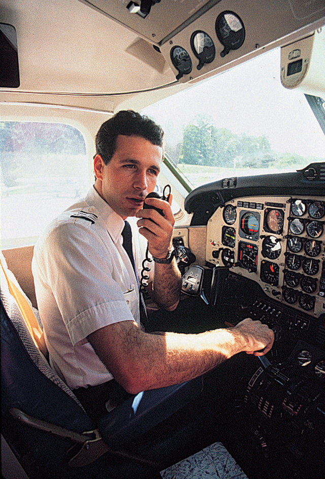 Airline pilot using a radio