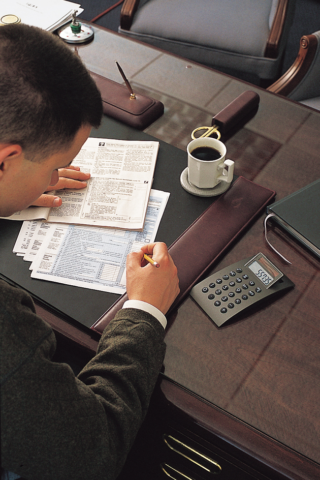 Accountant using a calculator