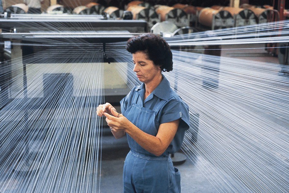 Woman working with rayon in textile factory