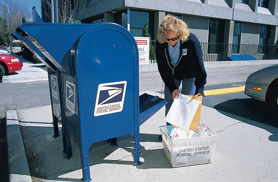 Letter carrier collecting mail