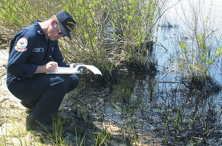 Coastguardsman checking for oil-spill damage