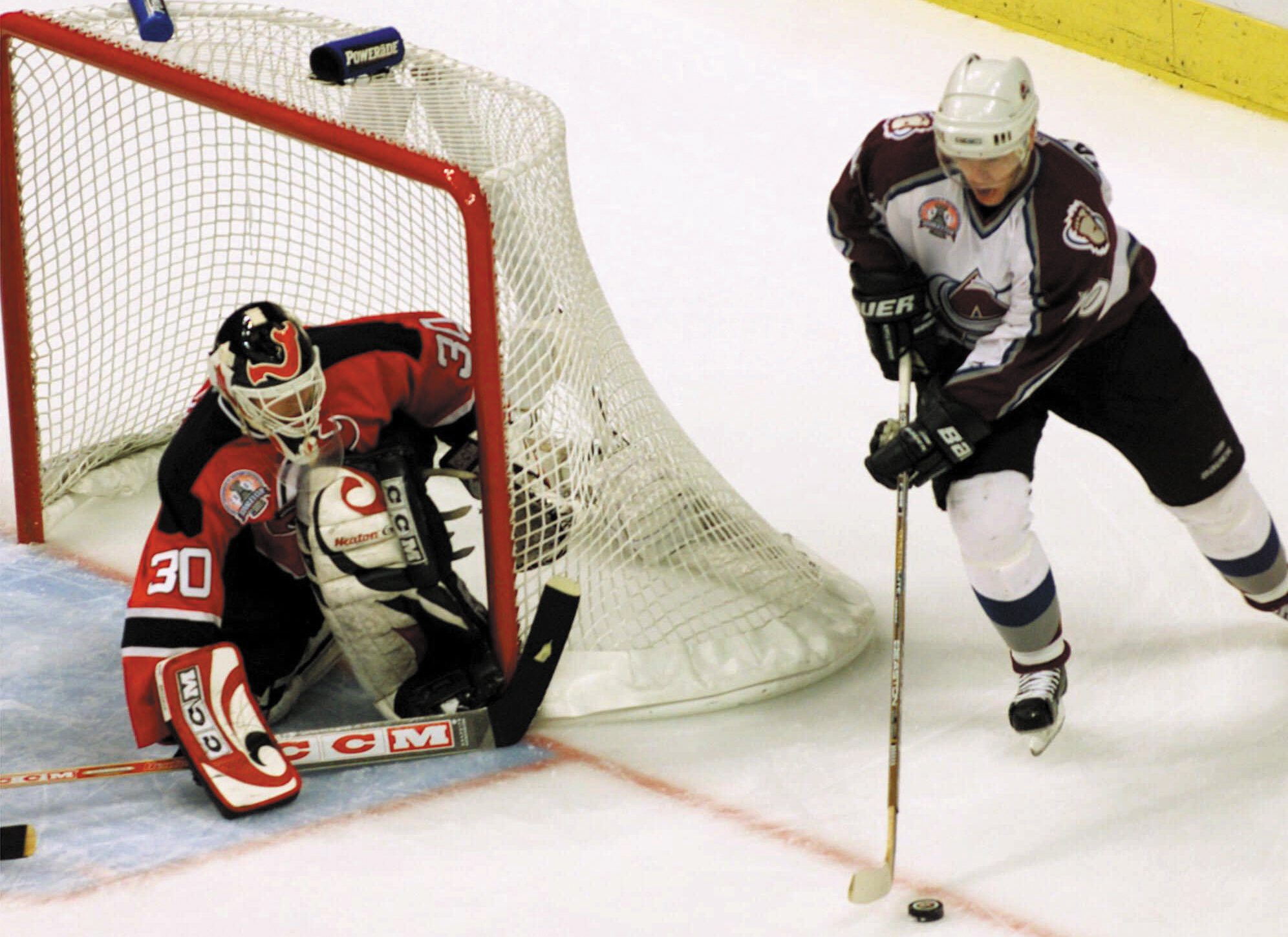 Alex Tanguay of the Colorado Avalanche shoots against New Jersey Devils goalkeeper Martin Brodeur