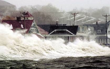 Waves crash over a seawall in Massachusetts