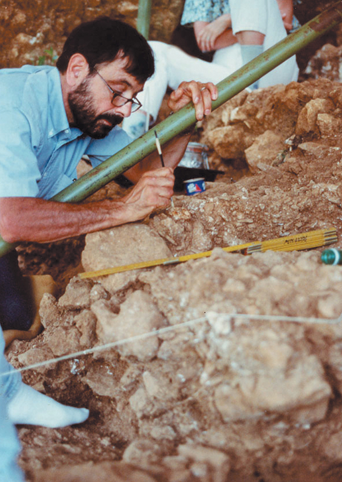 Anthropologist excavates a site