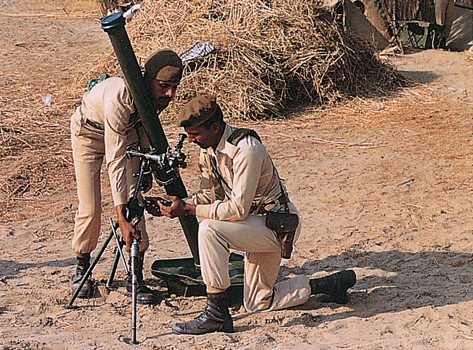 Soldiers aim a mortar