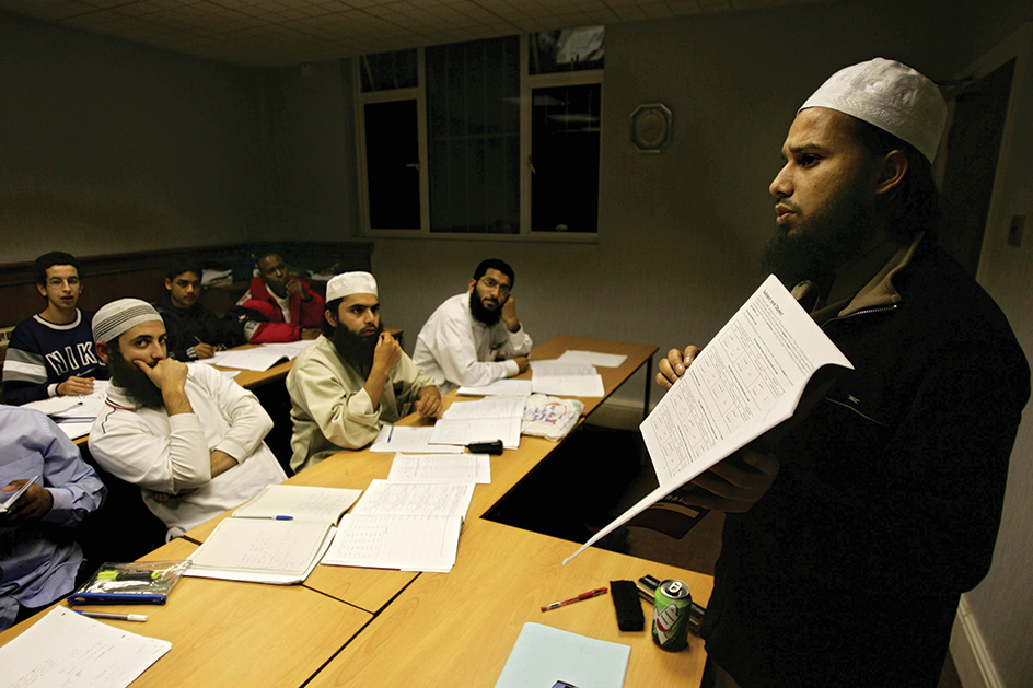 British Muslim teacher with students