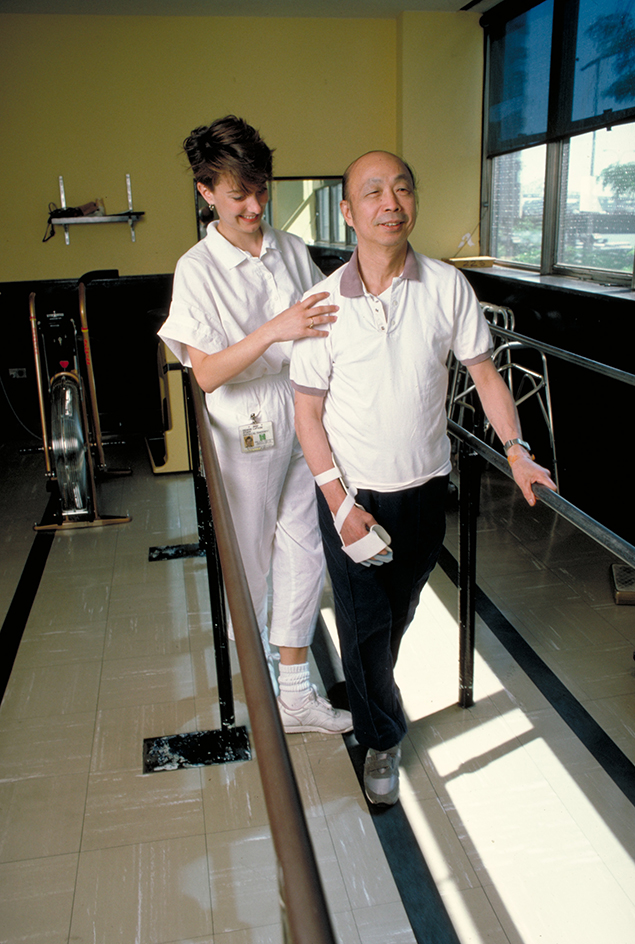 Physical therapist assists a stroke patient