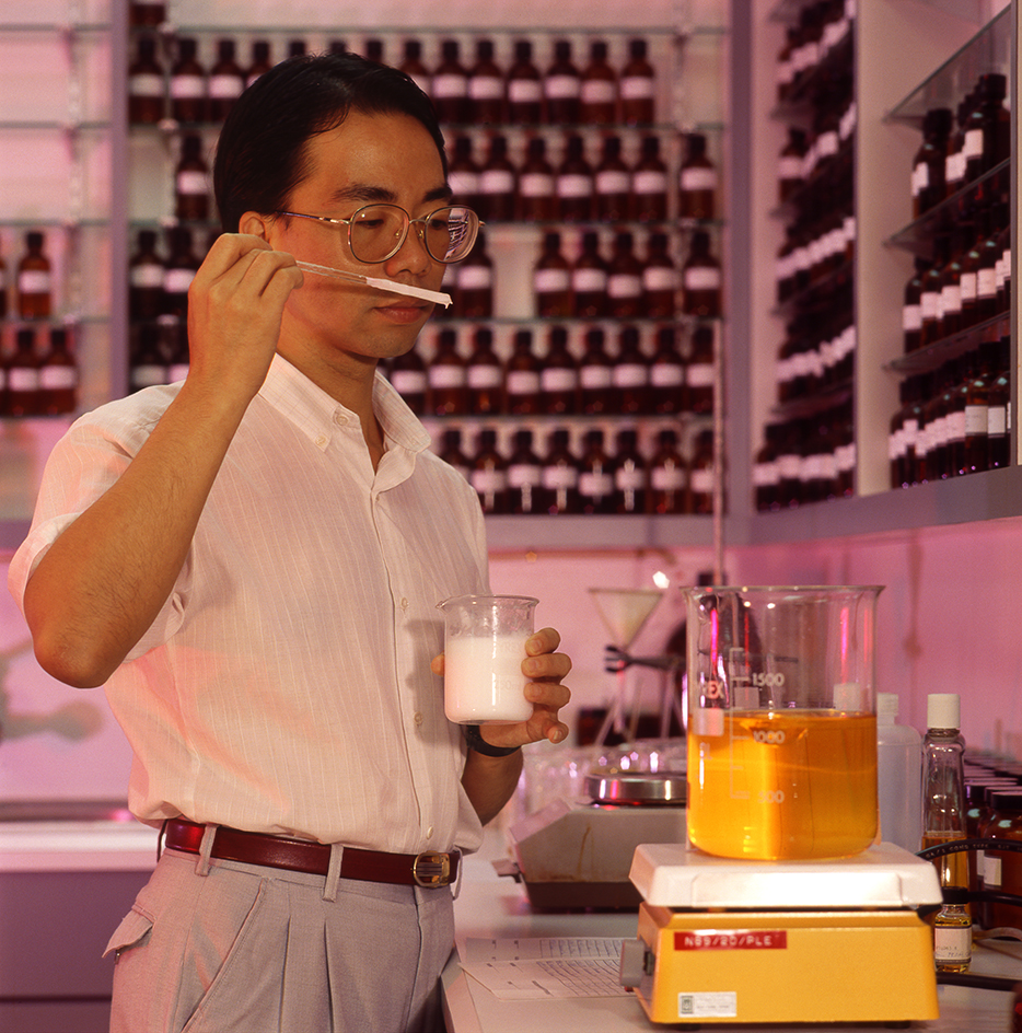 A skilled perfume worker uses his nose to test perfume