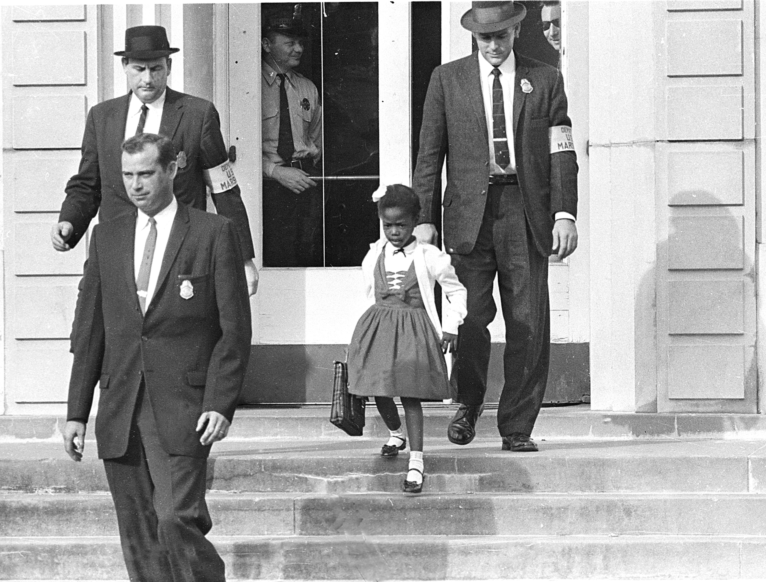 U. S. marshals escort Ruby Bridges from school