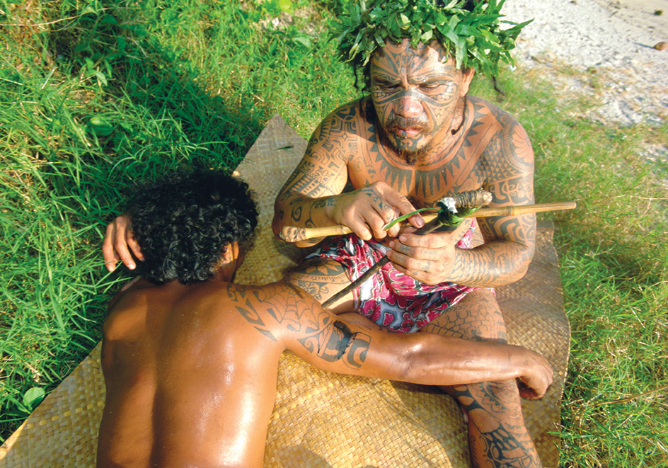 French Polynesian man receiving a tattoo