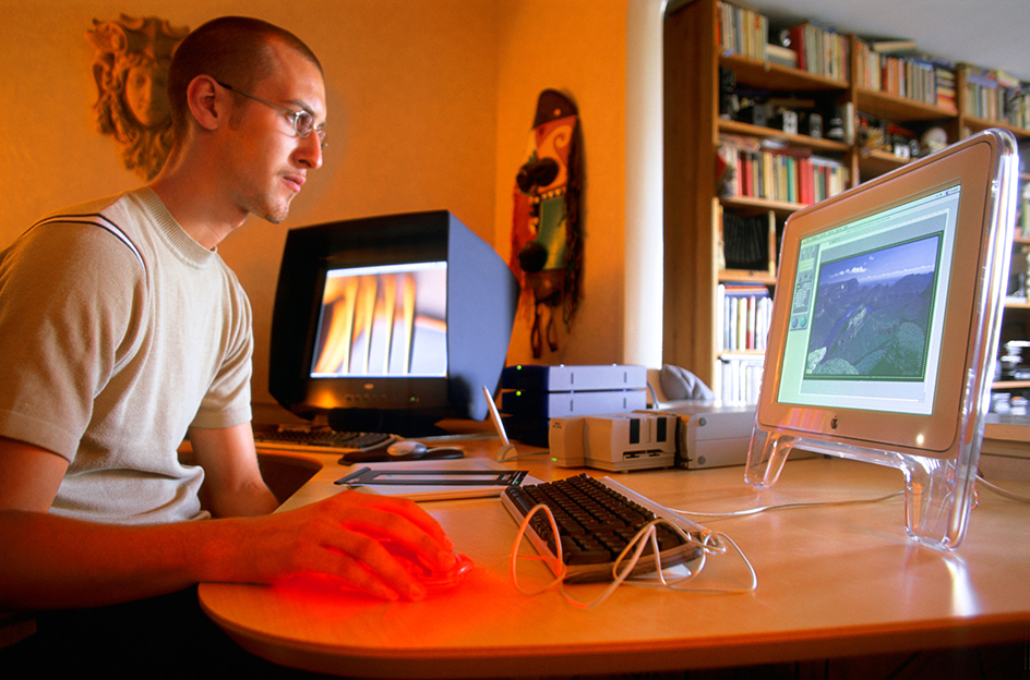 A digital artist uses computer software to design websites.