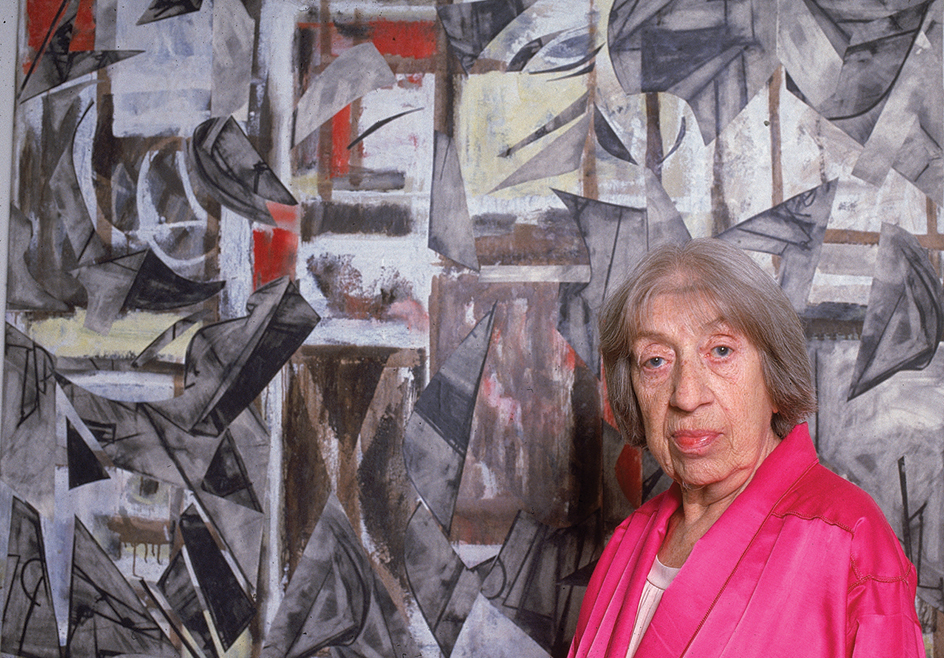 Lee Krasner with one of her paintings