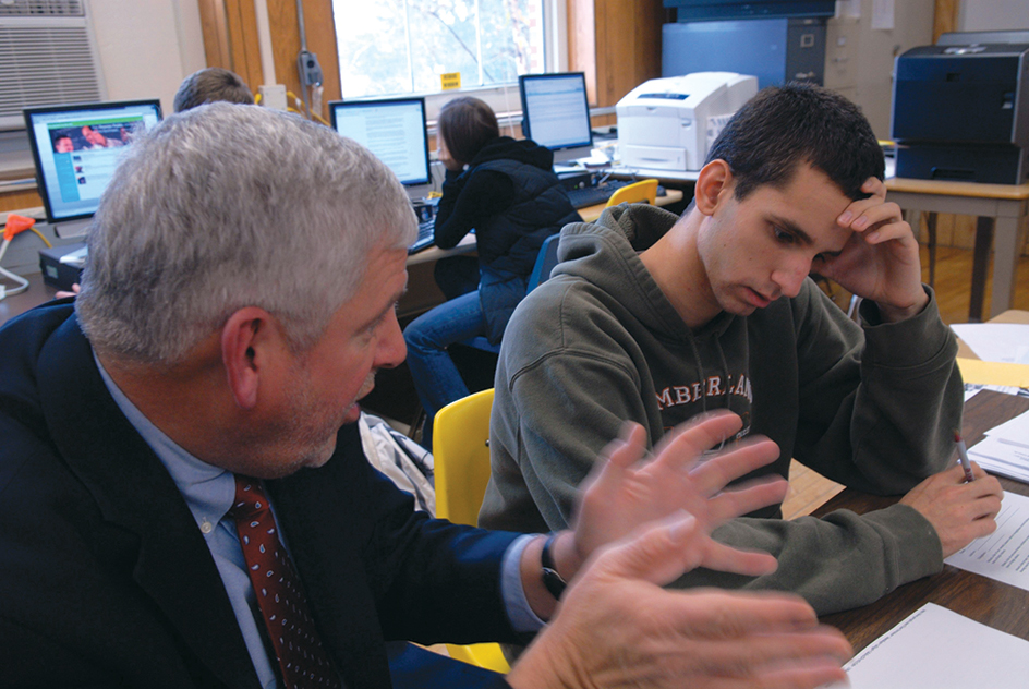 A guidance counselor talks with a student