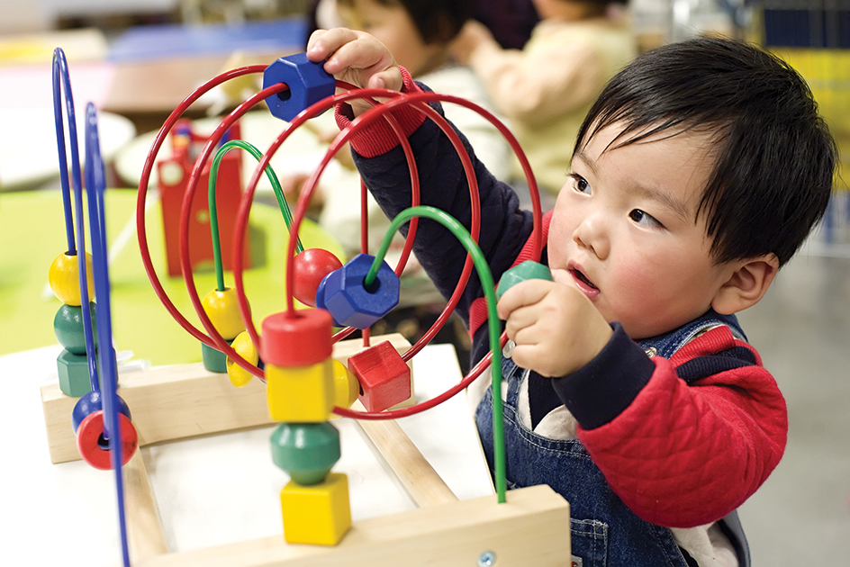 Toddler playing with toy