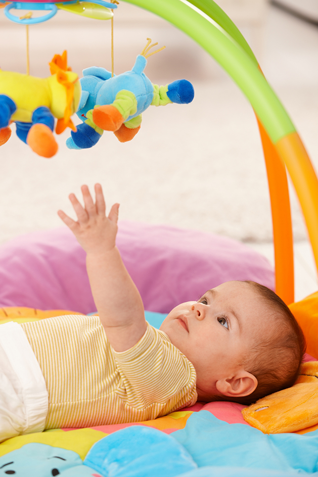 Baby reaching for toy