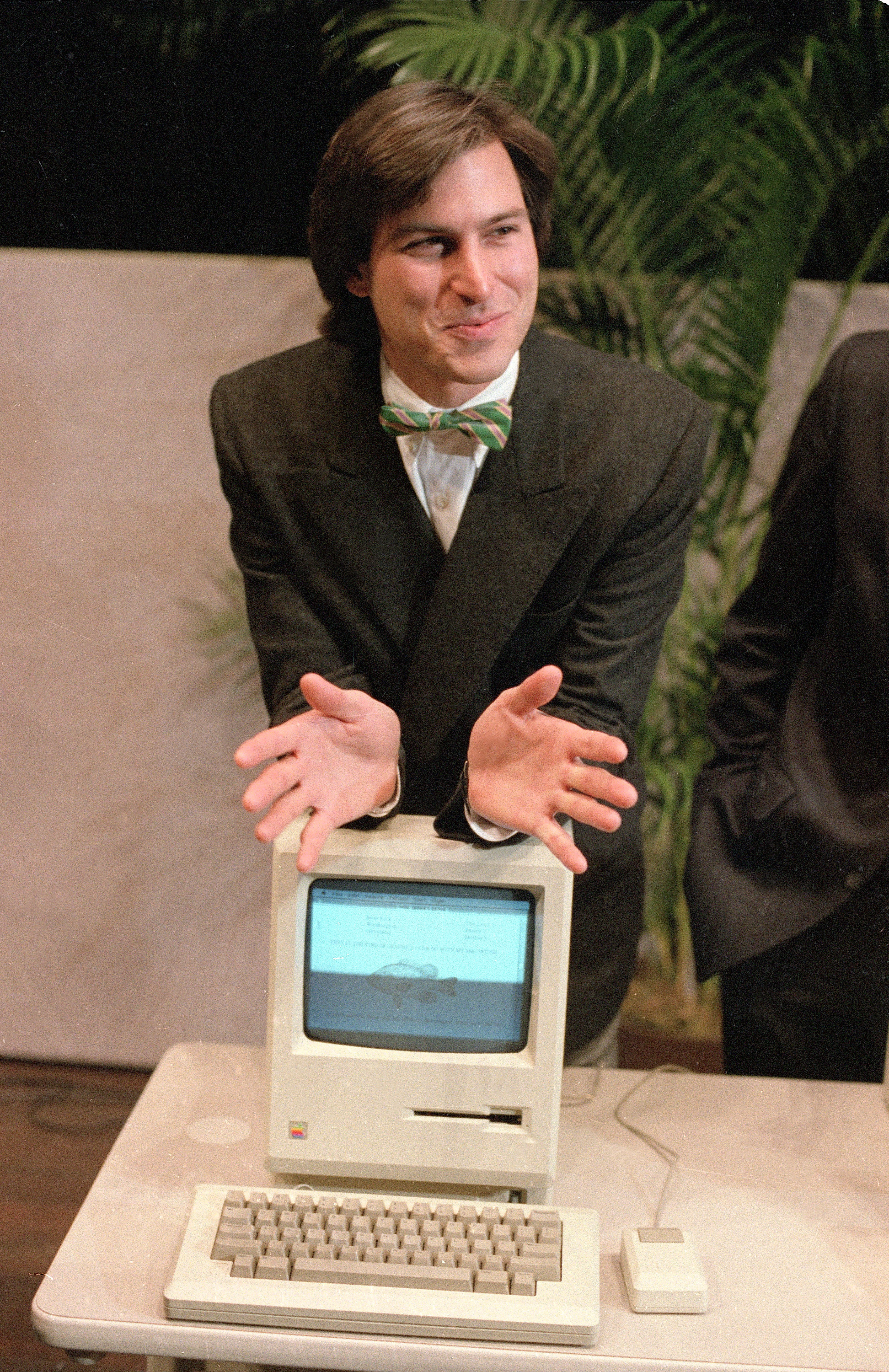 Apple cofounder Steve Jobs with the Macintosh personal computer