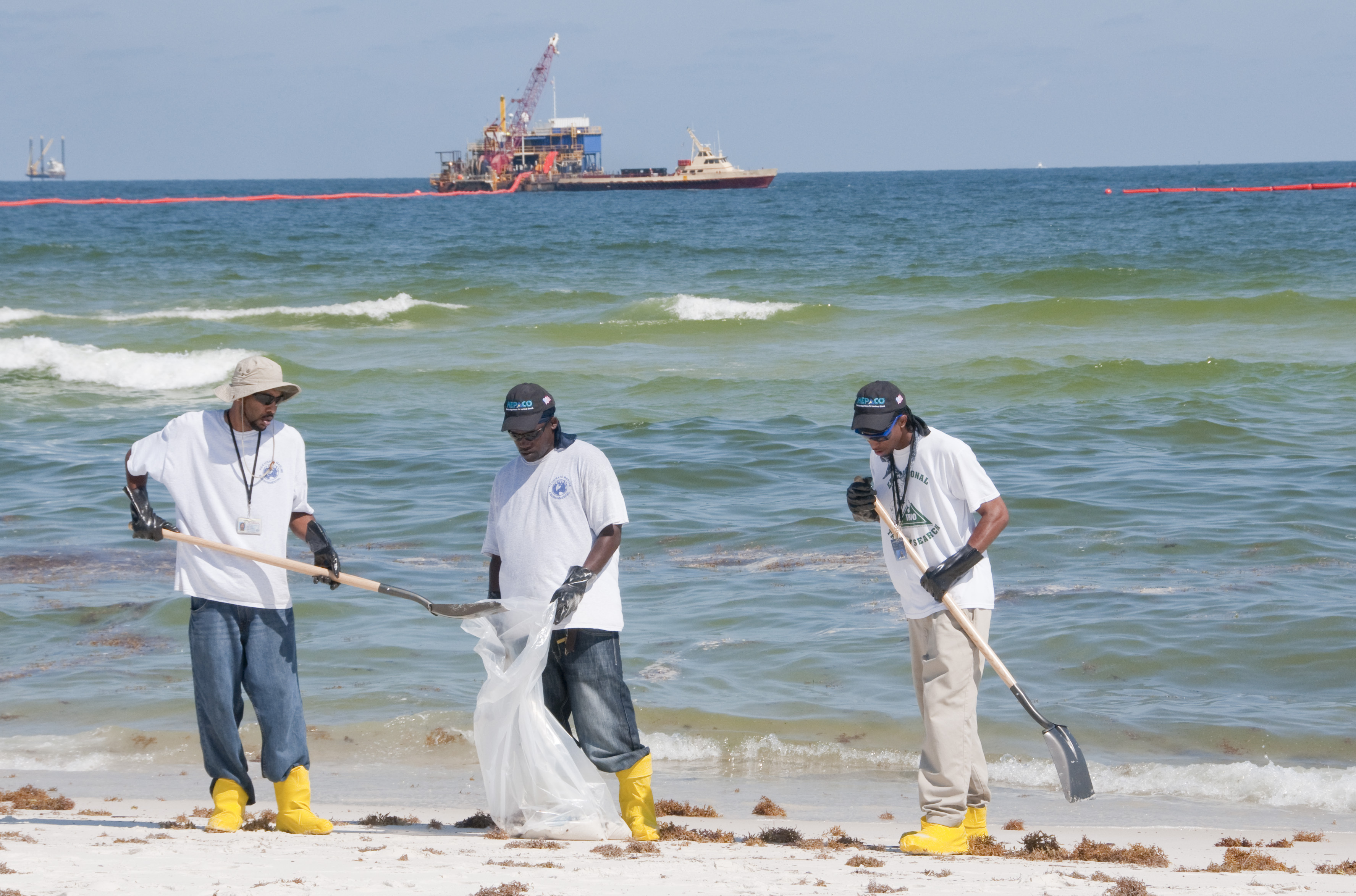 Workers cleaning up after an oil spill