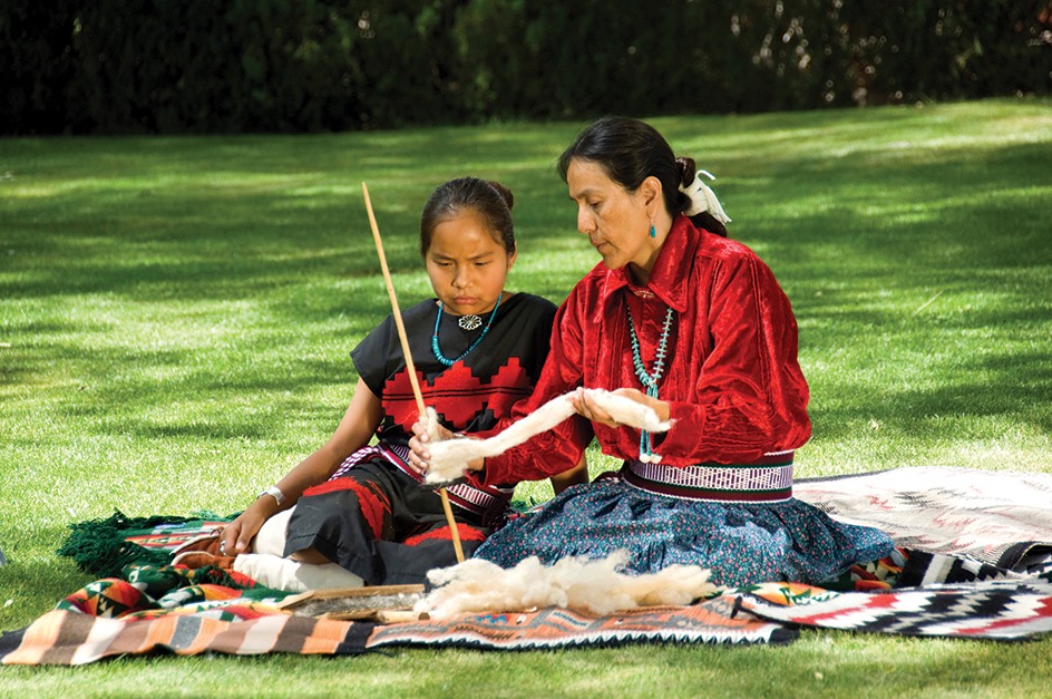 Navajo woman teaches spinning