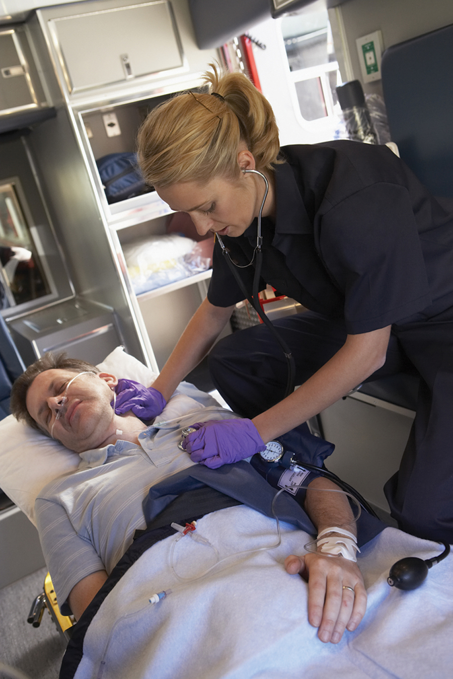 A paramedic provides care in an ambulance