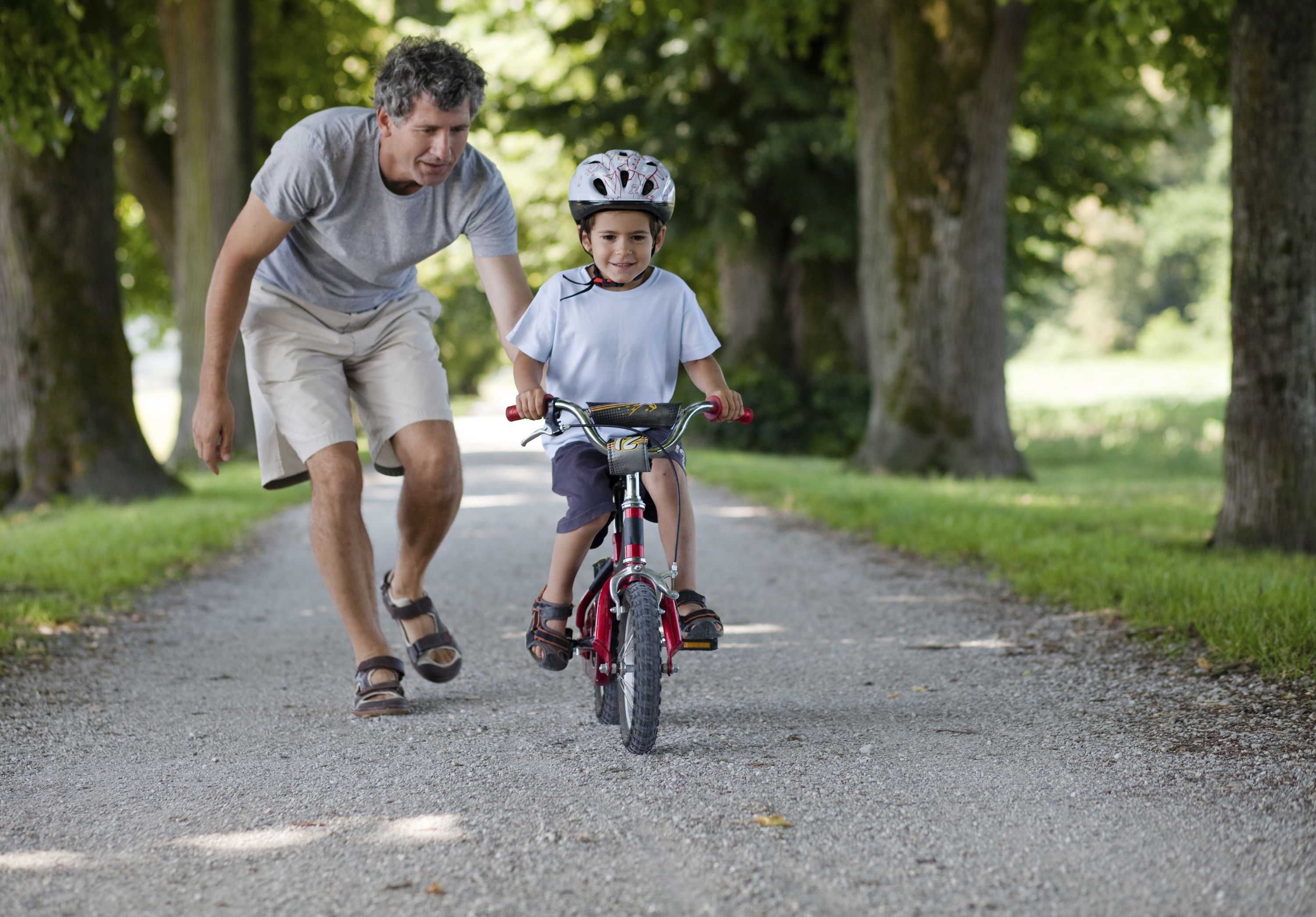 Father teaching his son to ride a bicycle