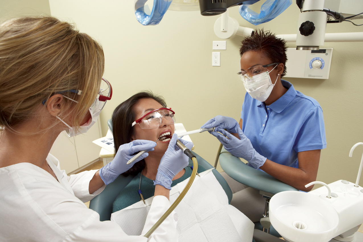 Dentist and dental assistant