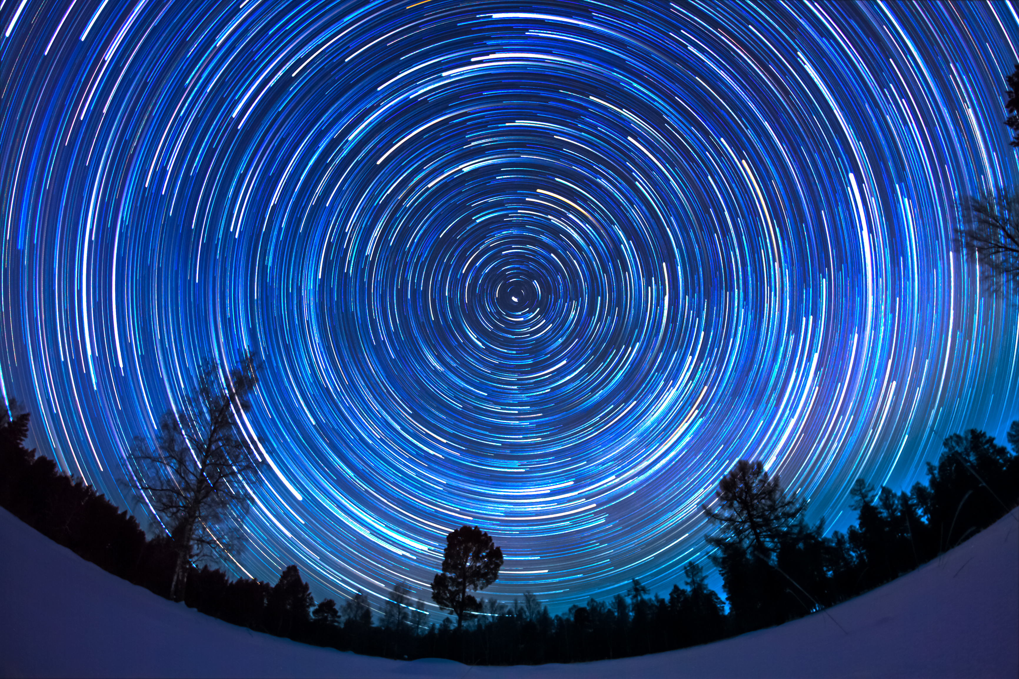 Stars trace paths across the night sky