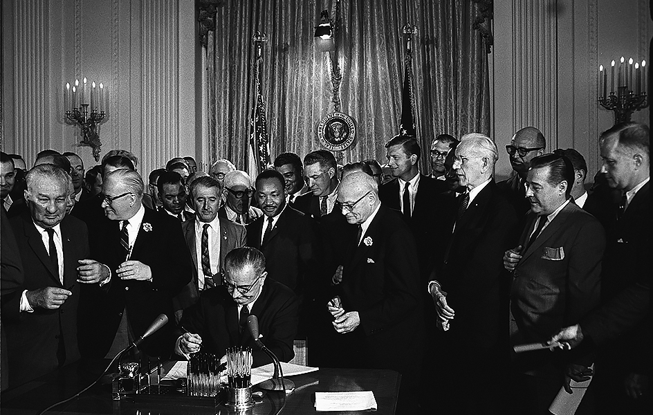 President Lyndon Johnson signing the Civil Rights Act of 1964