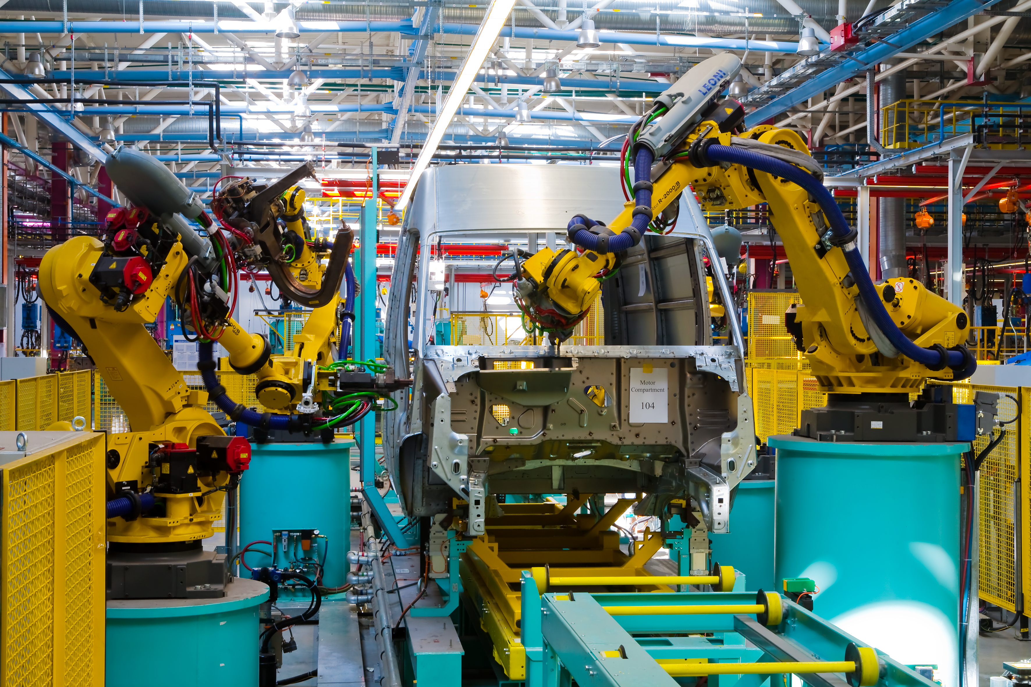 Robotic arms at work in an automobile factory