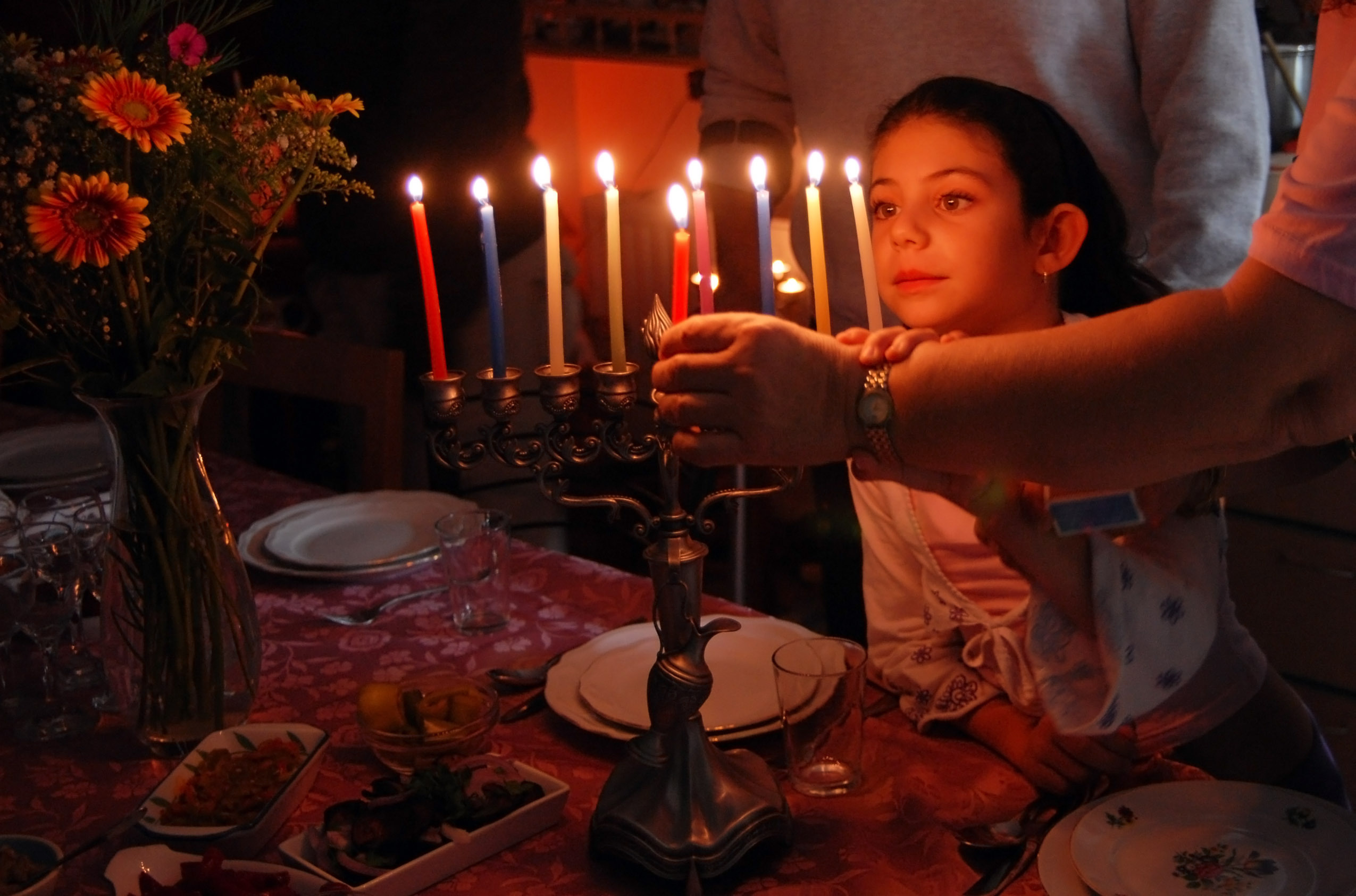 Jews light a menorah lamp to celebrate Hanukkah