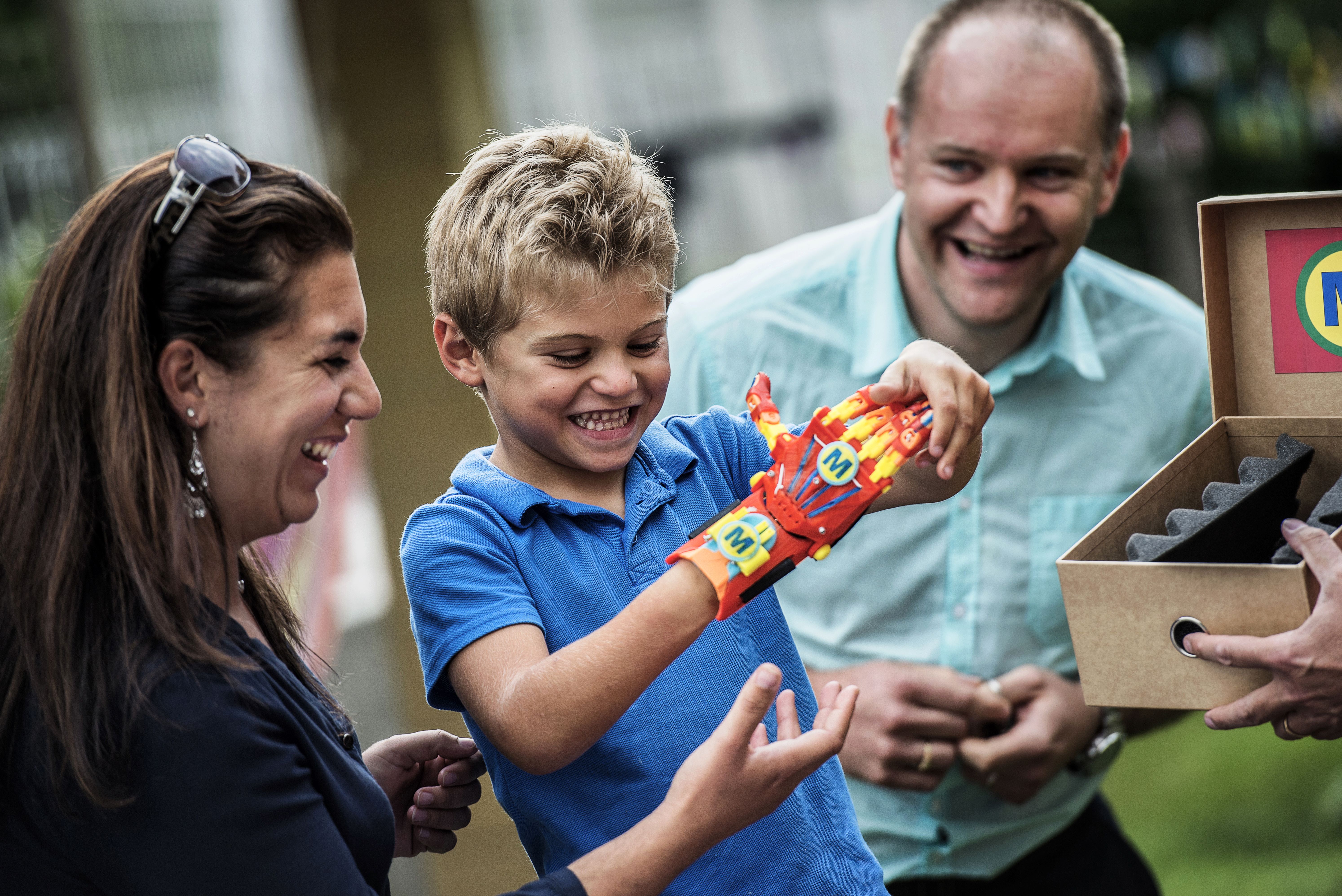 Child trying on a 3D printed hand