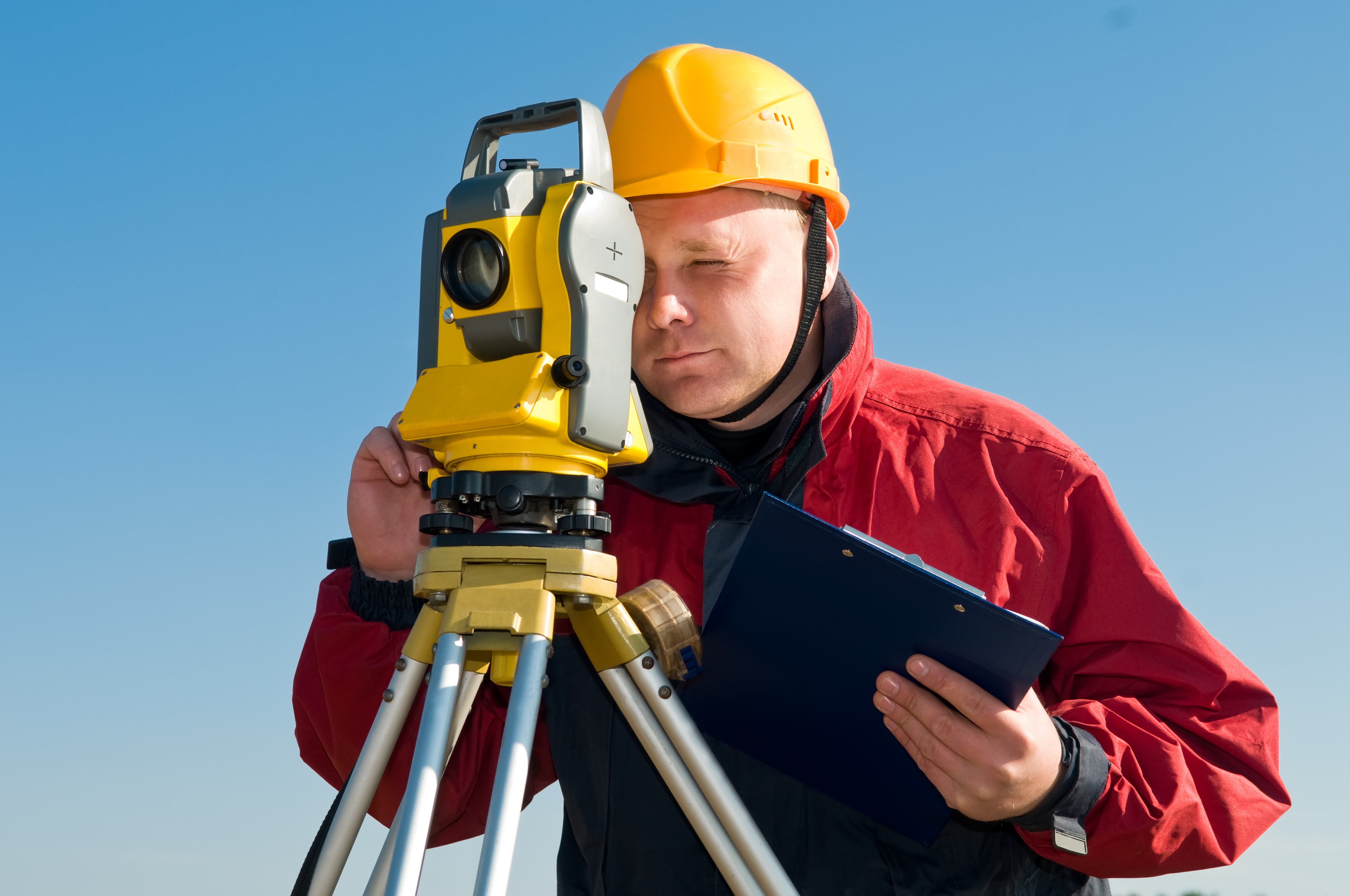 Surveyor using a total station 