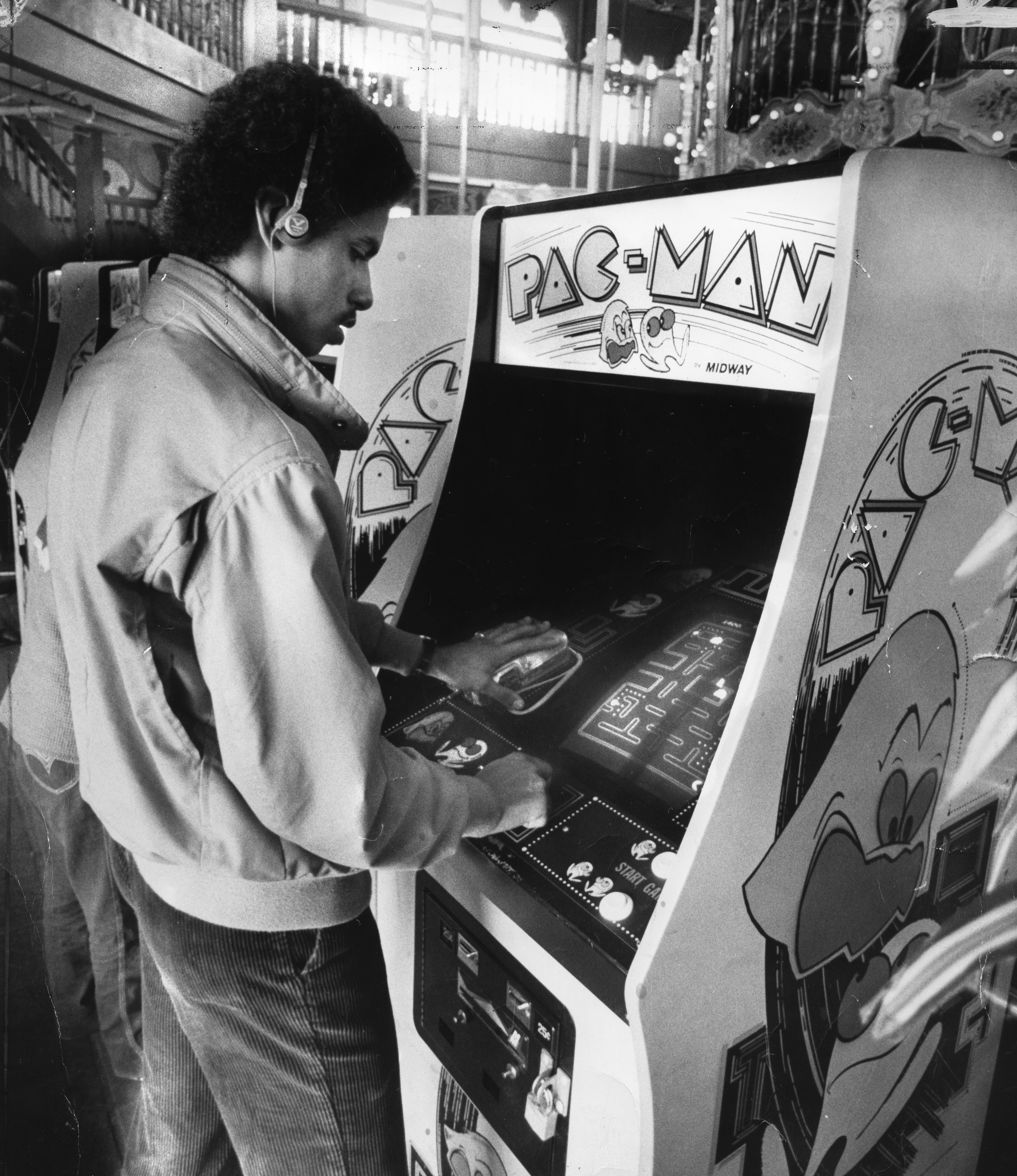 Teenager playing the arcade game Pac-Man