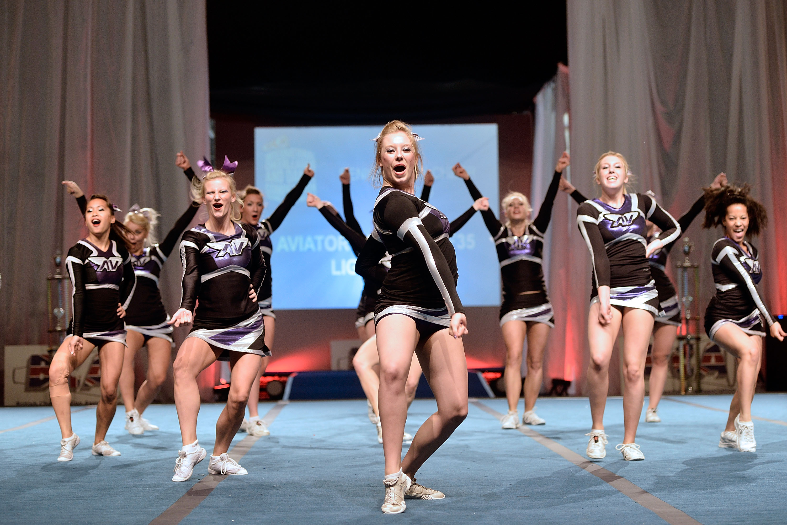 Competitive cheerleaders perform a choreographed routine