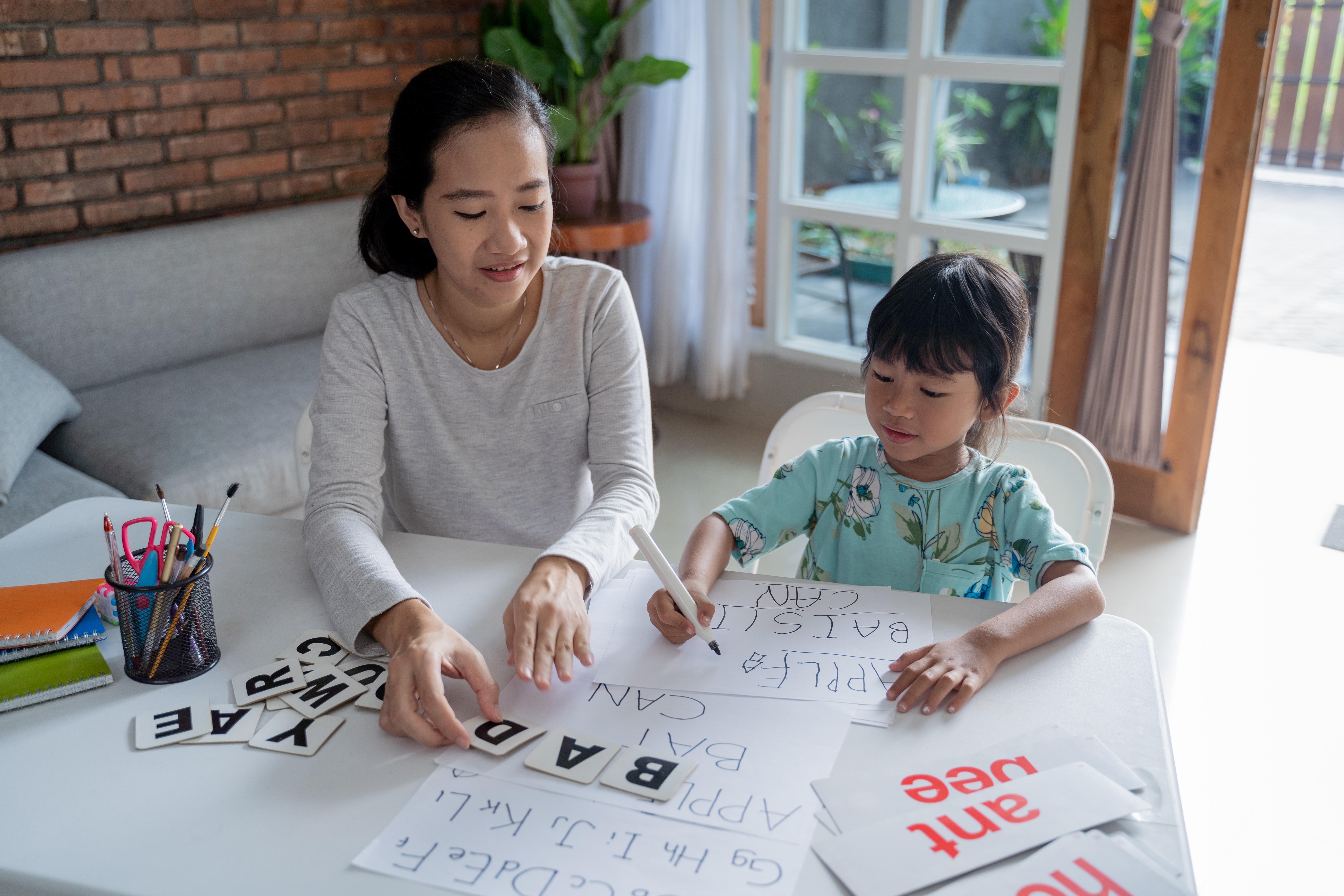 A mother homeschooling her daughter