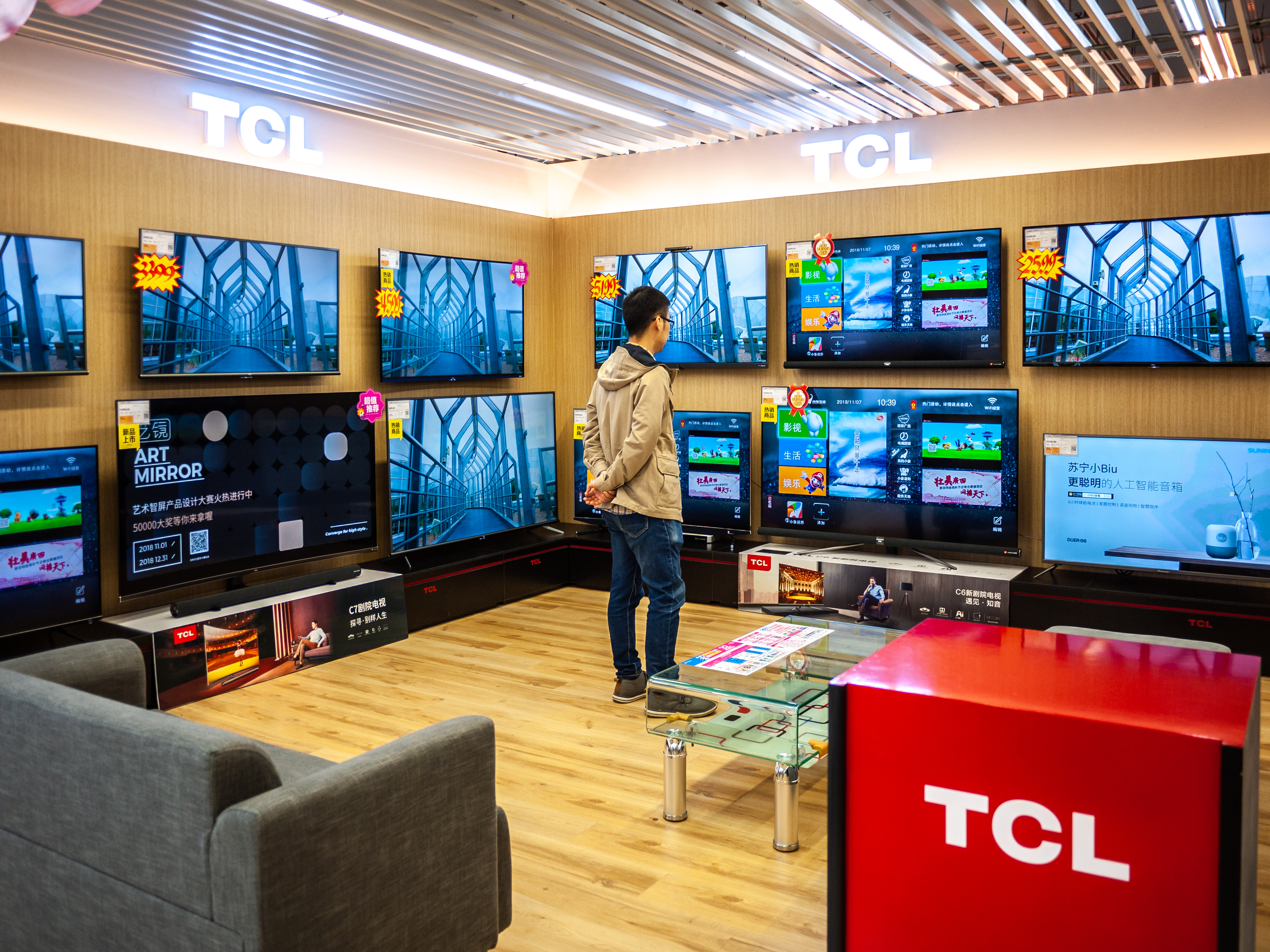 A shopper browses flat-panel TV sets in China