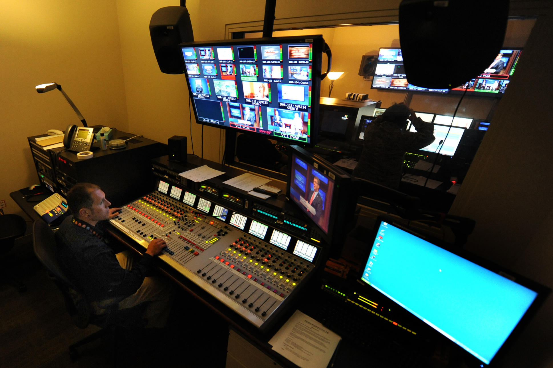 An audio engineer working during a television broadcast