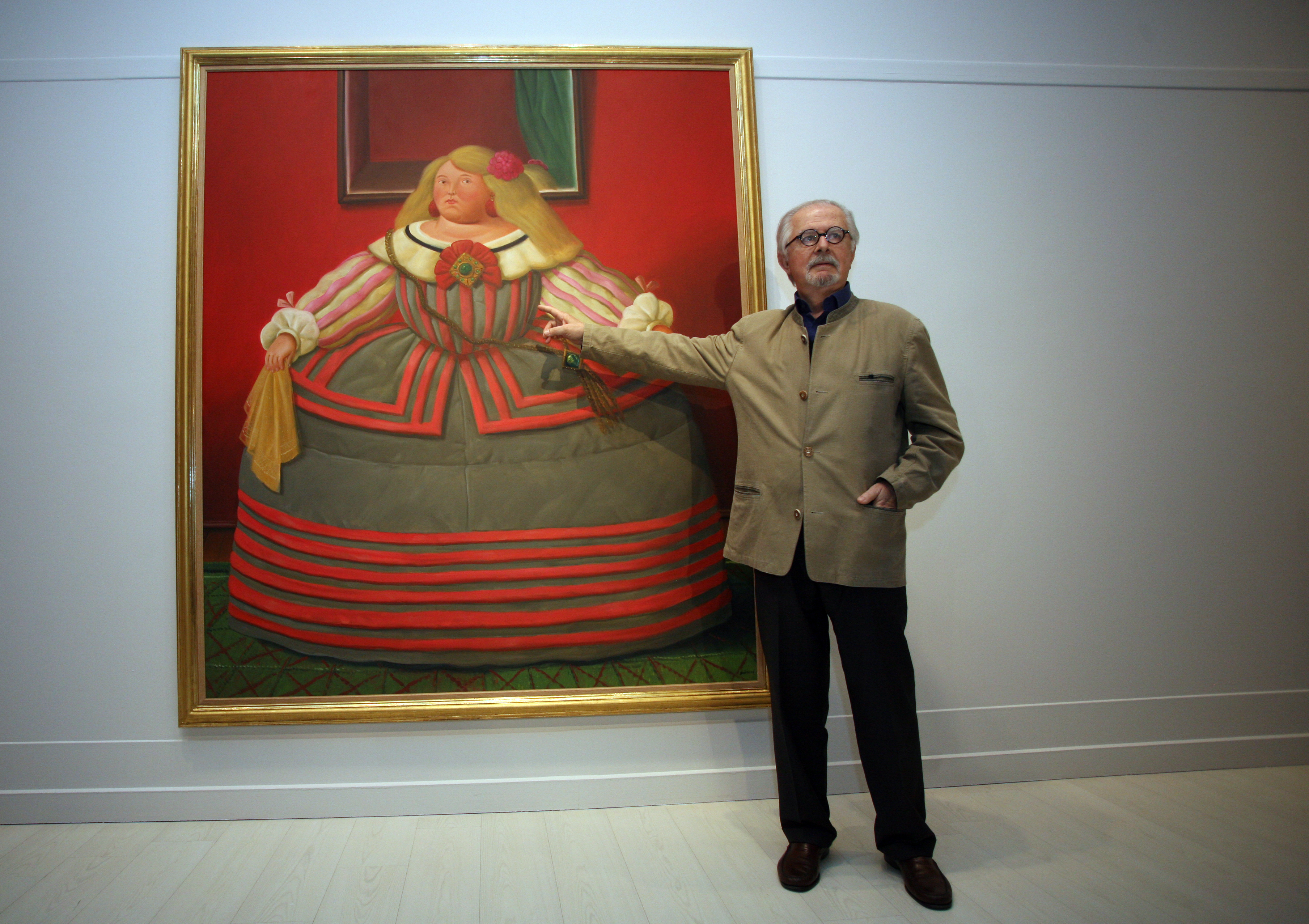 Colombian artist Fernando Botero with his painting After Velazquez