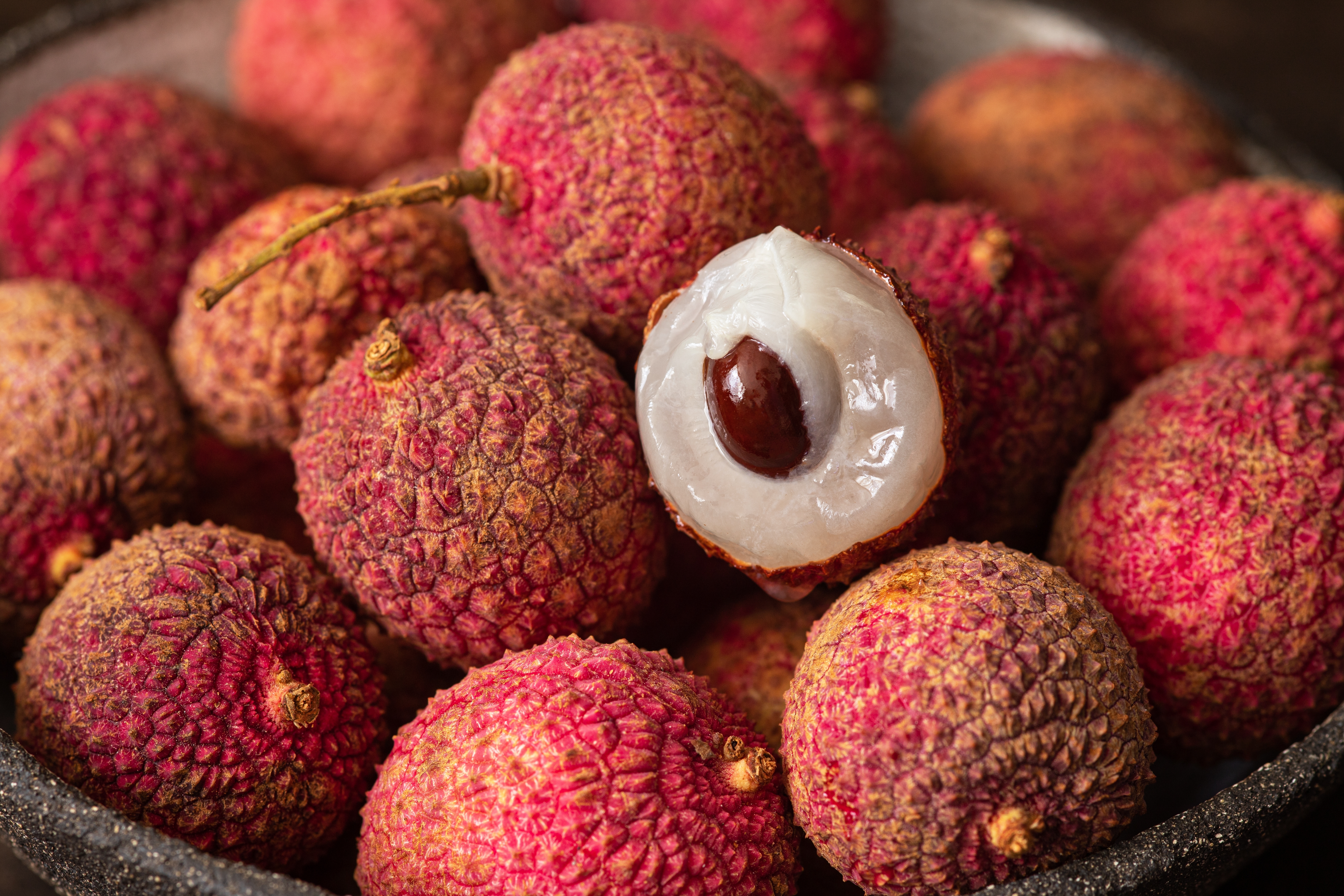 Rough, red skin and white flesh of litchi fruit