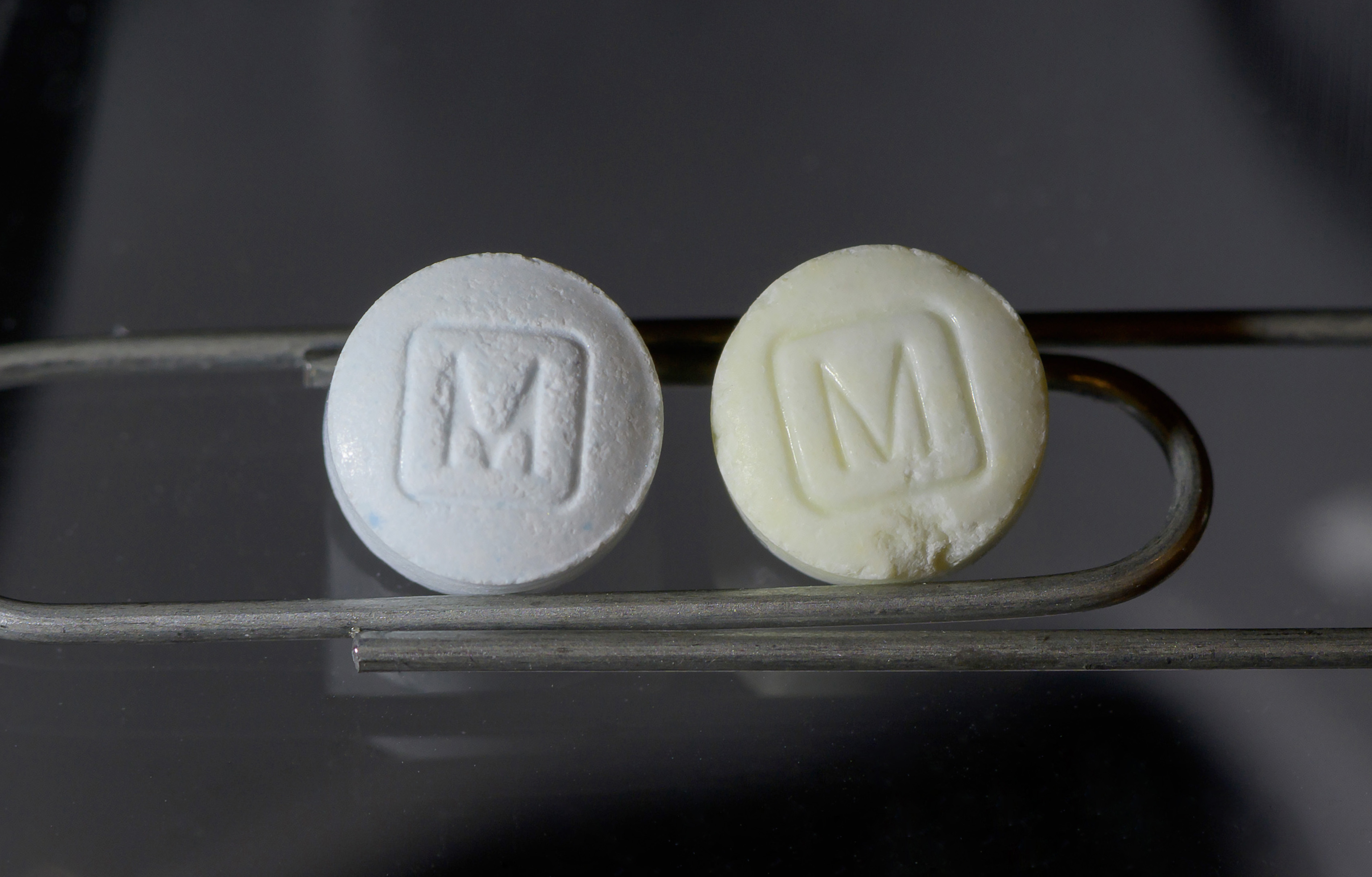 Legitimate (left) and counterfeit (right) oxycodone pills